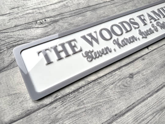 Personalized family nameplate on a wooden surface