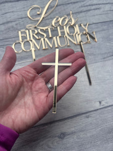Gold cross and 'Forever Communion' decorative items on a wooden surface