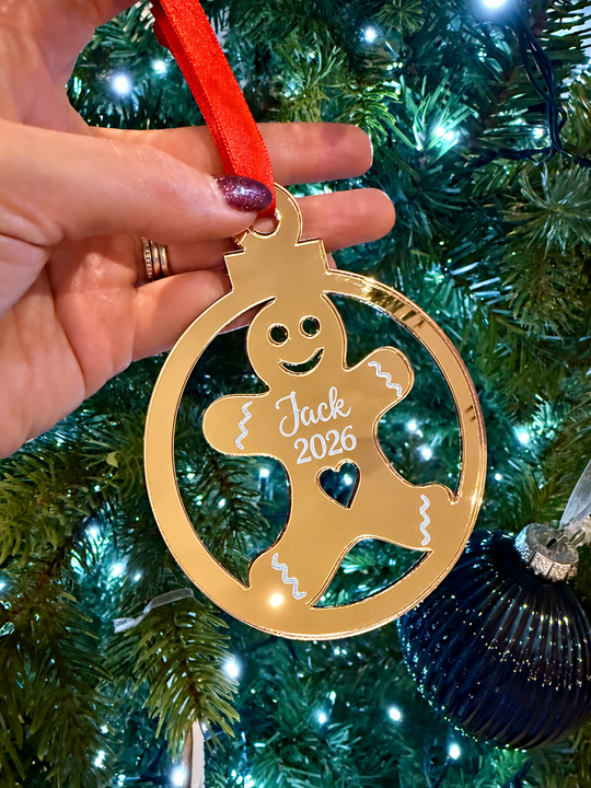 Close-up of personalised gingerbread Christmas ornament showing engraved name and 2026