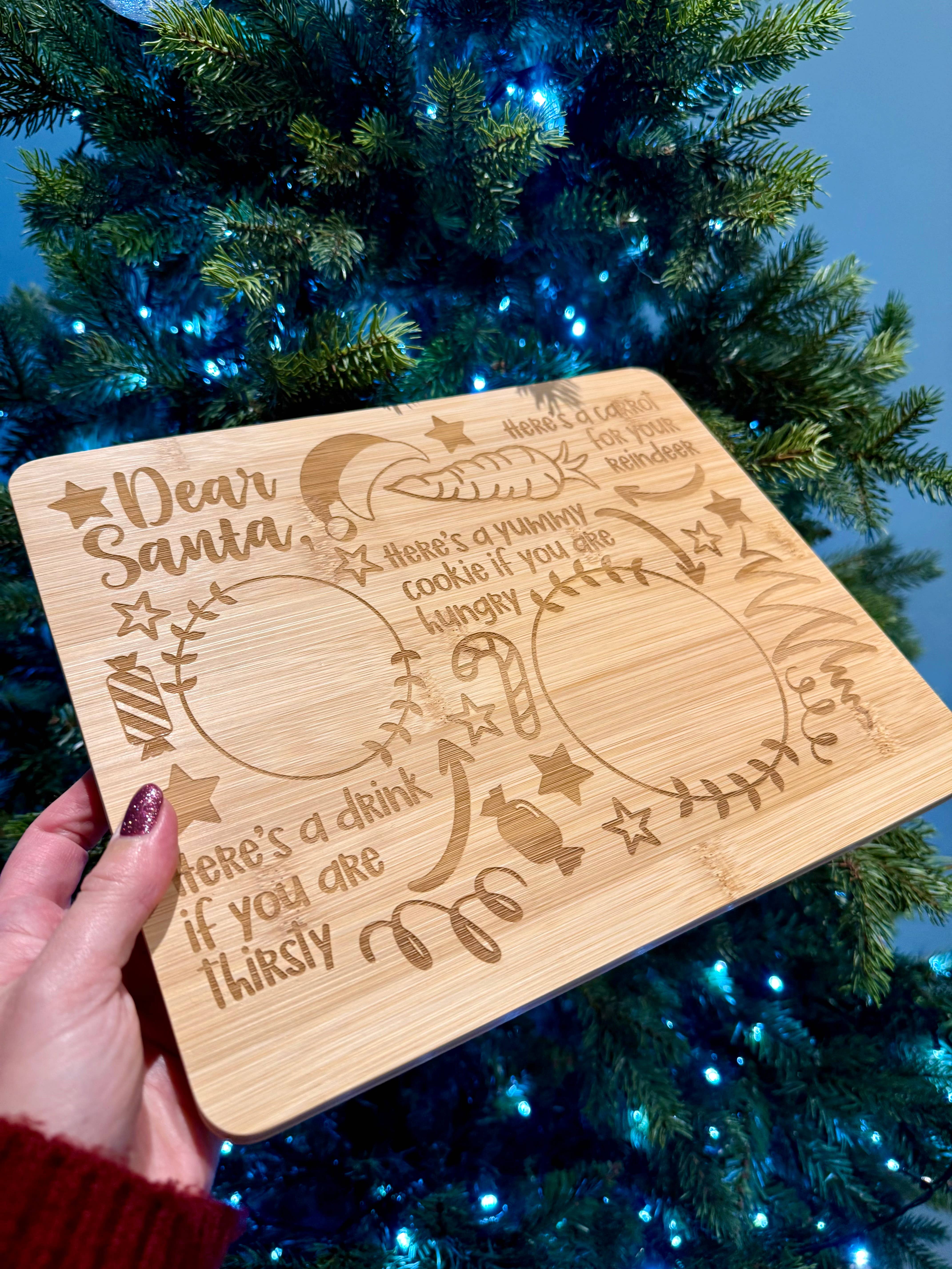 Wooden plaque with engraved text in front of a decorated Christmas tree