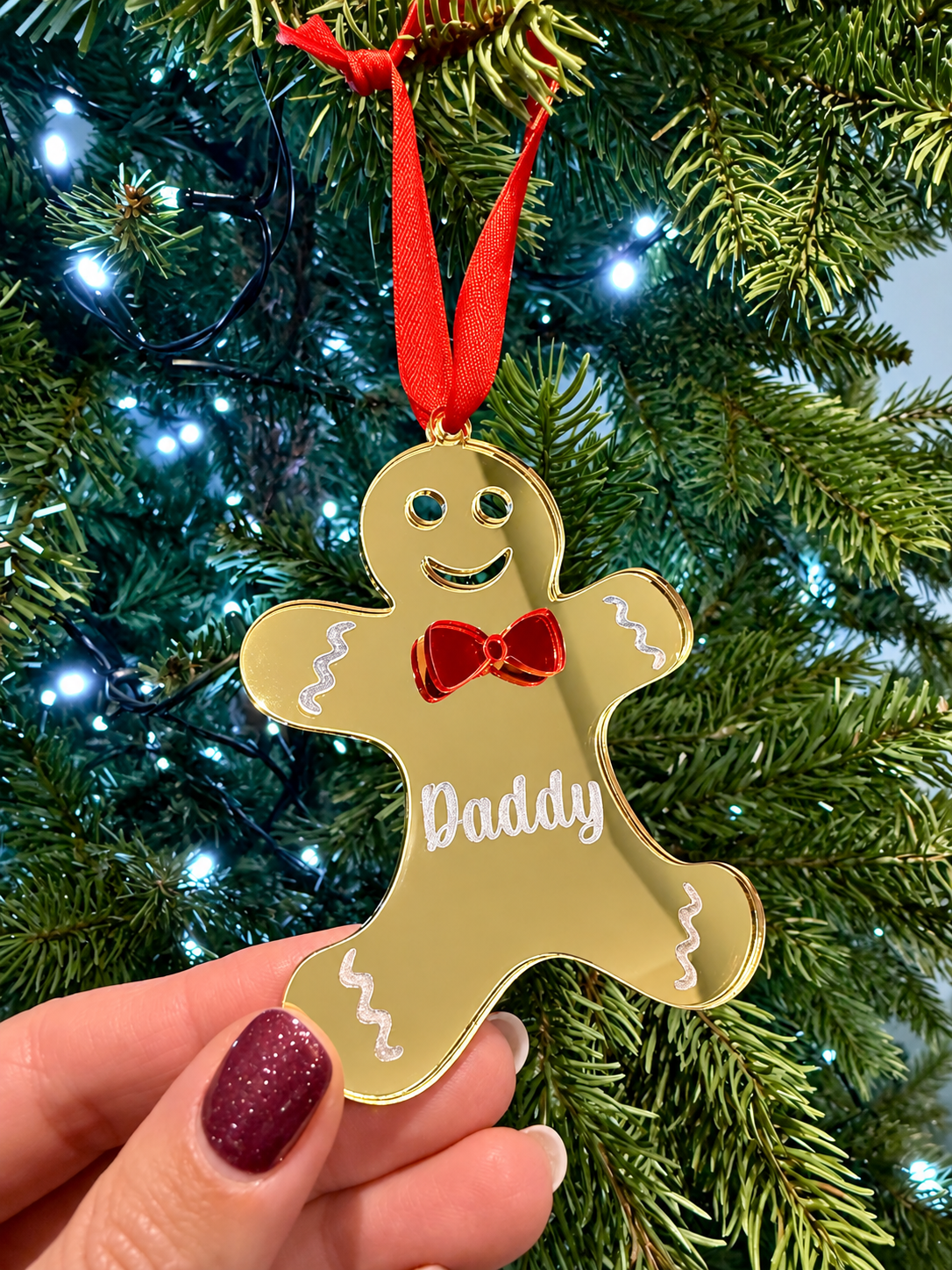 Load image into Gallery viewer, Personalised blue acrylic gingerbread Christmas ornament engraved with Daddy on a Christmas tree
