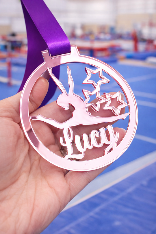 rose gold mirror acrylic personalised gymnastics medal held in hand with custom name design