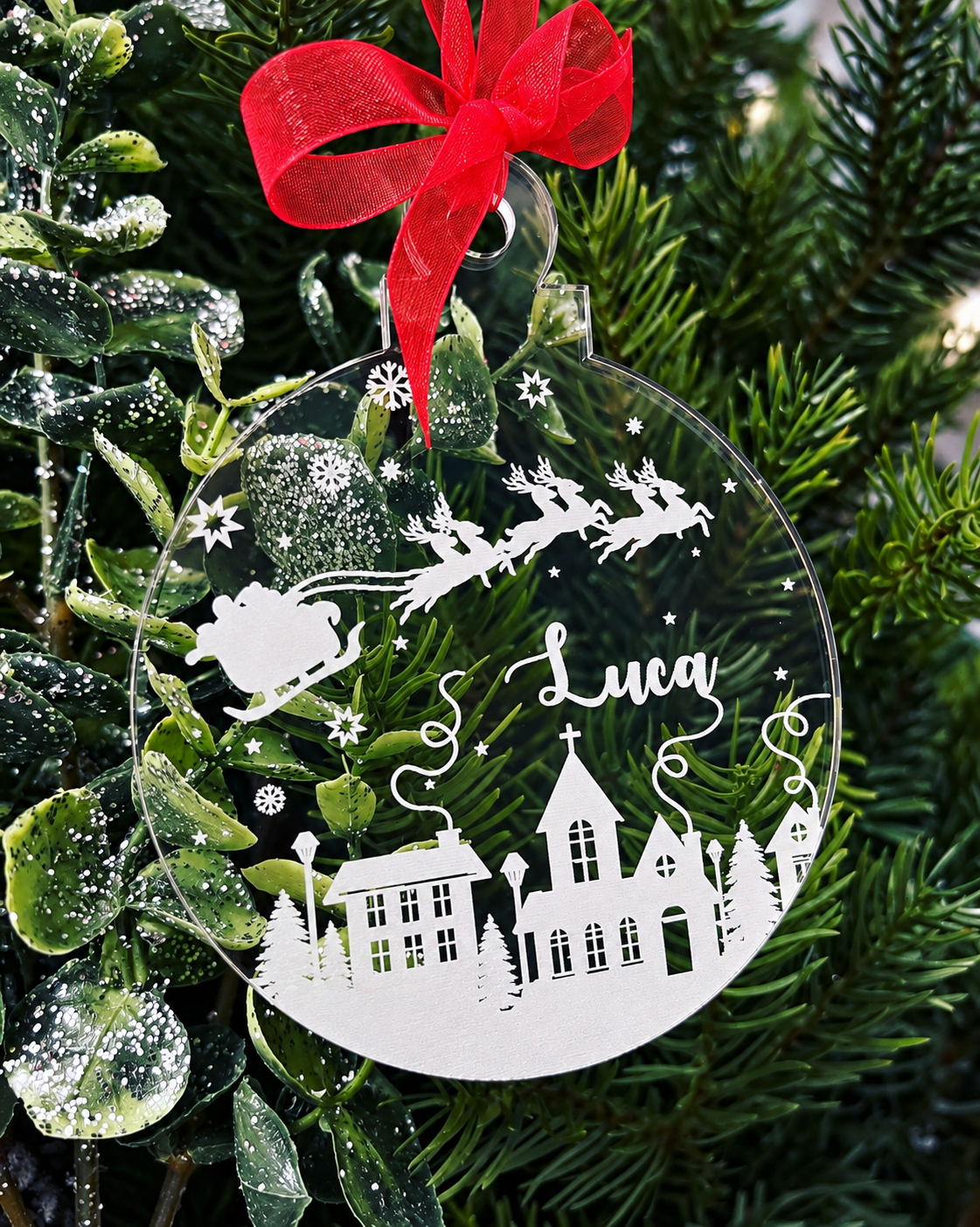 Load image into Gallery viewer, Personalised Christmas bauble with Santa and reindeer, snowy village, stars and name Luca on clear acrylic
