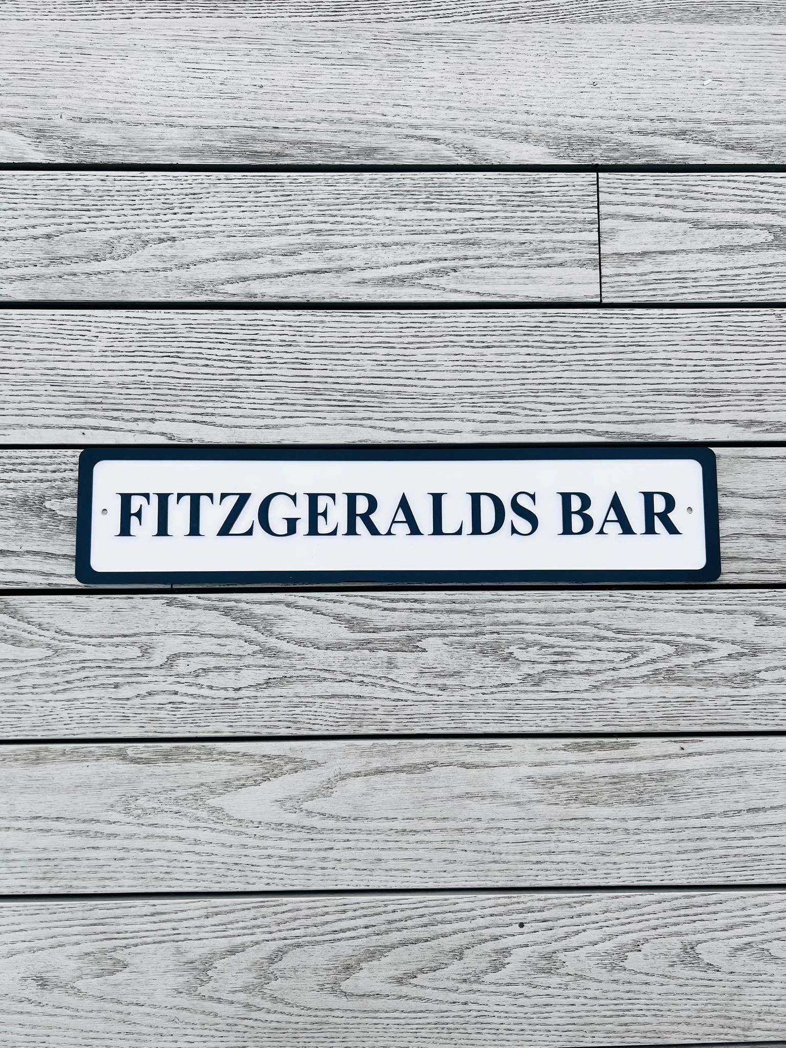 Load image into Gallery viewer, Personalised bar name sign mounted on outdoor wall, perfect for home bar, man cave, or garden pub decor
