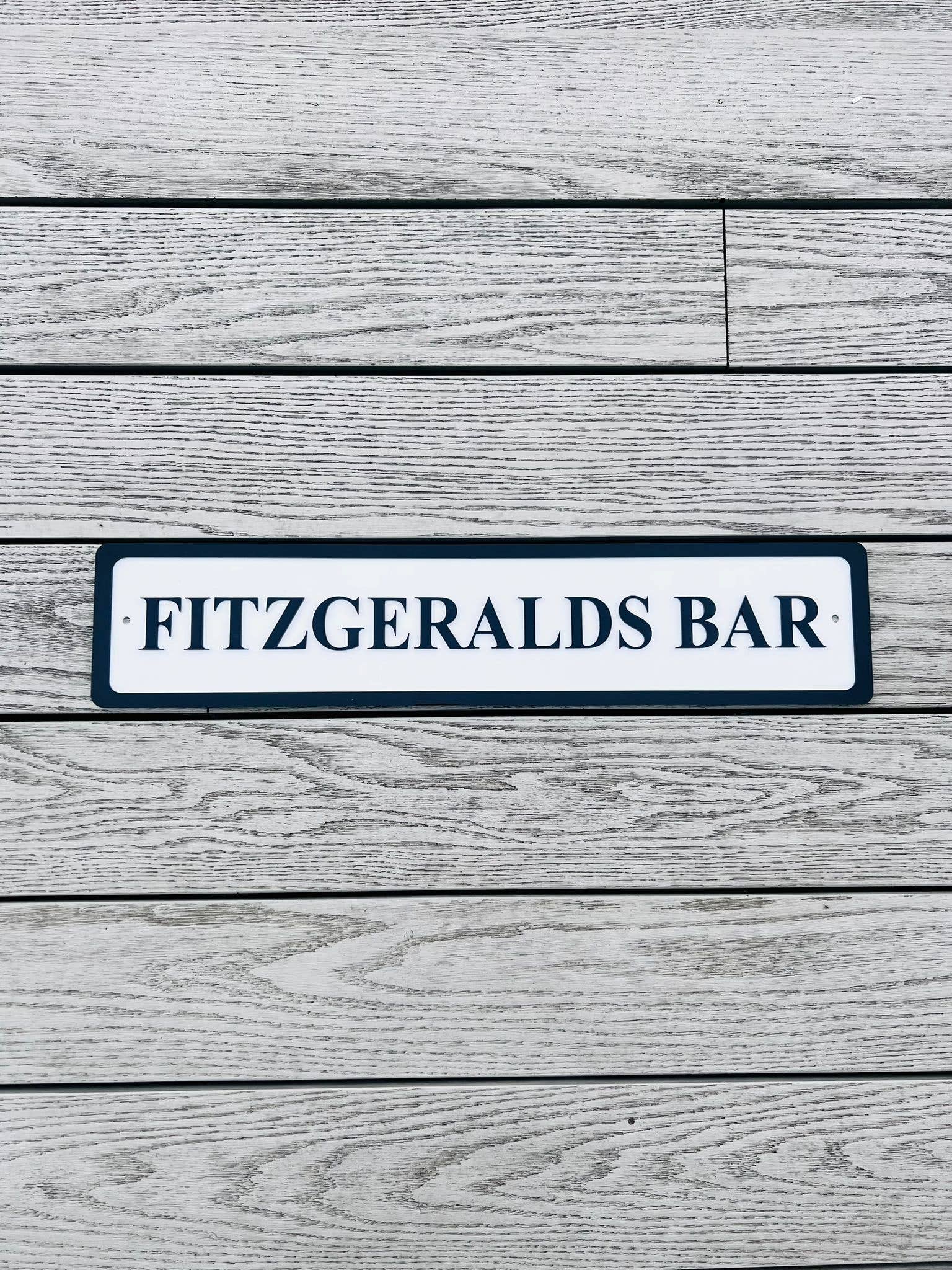 Personalised bar name sign mounted on outdoor wall, perfect for home bar, man cave, or garden pub decor