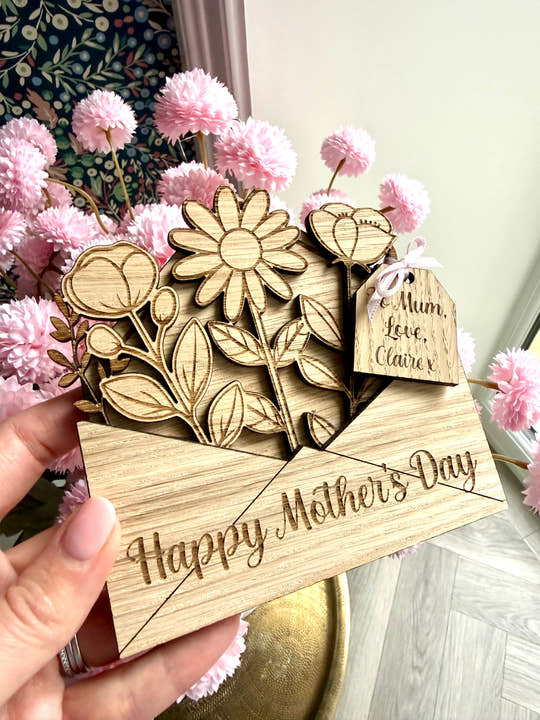 Personalised wooden Mothers day card with ‘Happy Mother’s day’ laser engraved on the front and a wooden gift tag with personalised gift details. 