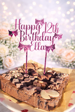 Load image into Gallery viewer, Pink mirrored acrylic personalised cake topper reading “Happy 12th Birthday Ella” displayed on a chocolate brownie celebration cake topped with assorted chocolates against a soft floral background.
