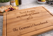 Load image into Gallery viewer, Wooden cheeseboard with engraved text on a kitchen counter.
