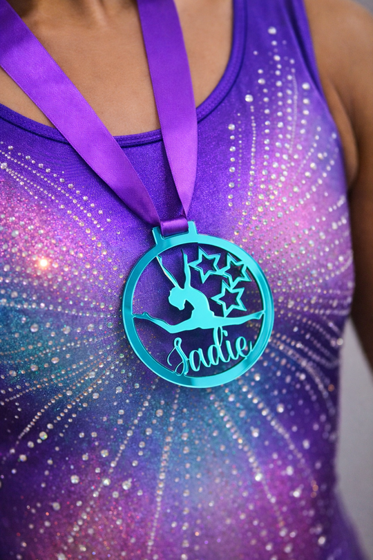 personalised gymnastics medal worn proudly by a gymnast wearing a leotard with custom name design