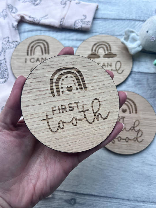 Personalised wooden baby milestone discs with rainbow theme, engraved with baby's milestones. Perfect for newborn gifts, baby showers, and capturing special moments.