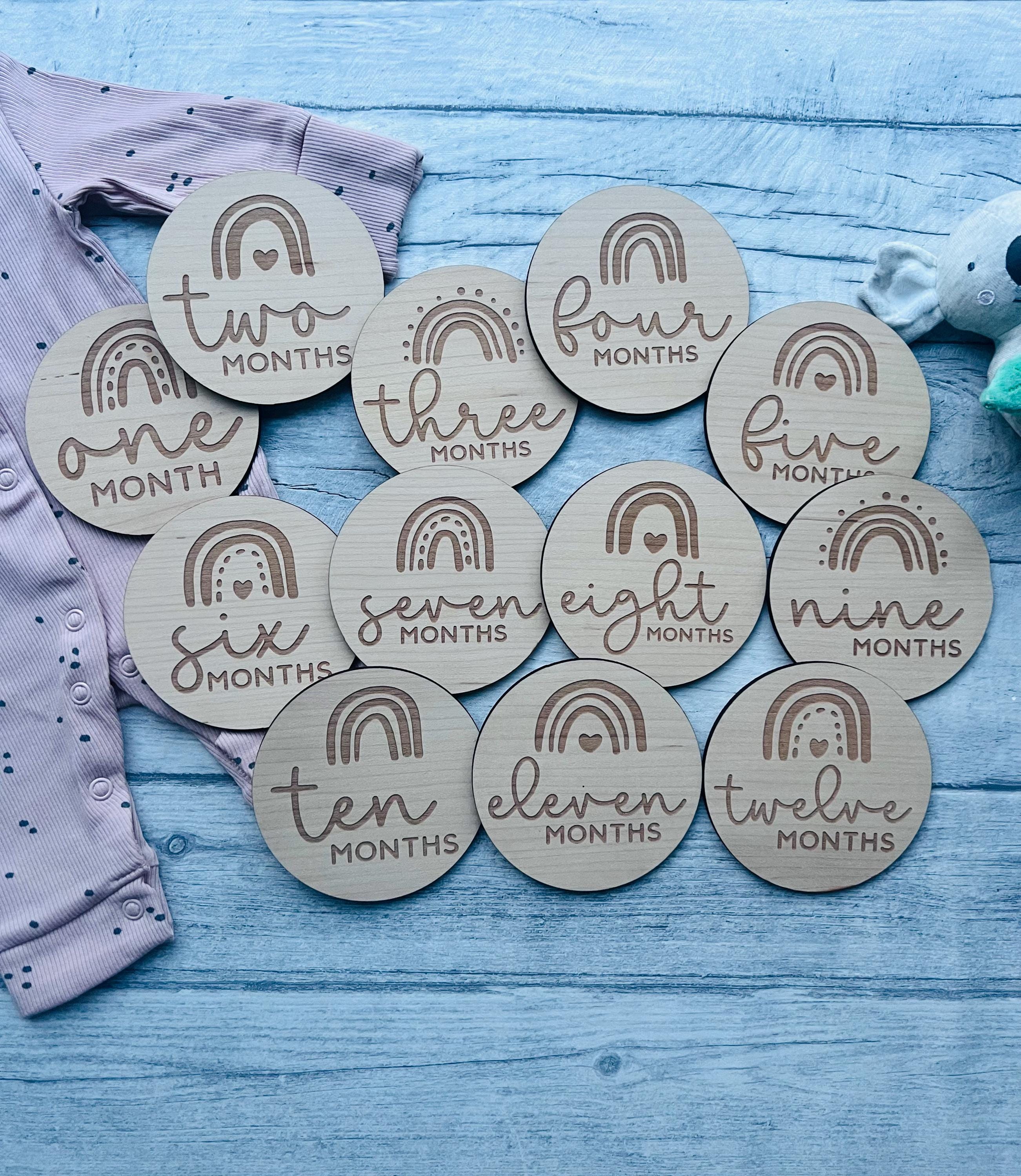 Load image into Gallery viewer, Personalised wooden baby milestone discs with rainbow theme, engraved with baby's milestones. Perfect for newborn gifts, baby showers, and capturing special moments.
