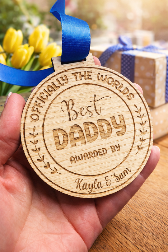 Close up personalised best daddy medal engraved wood fathers day gift UK with blue ribbon