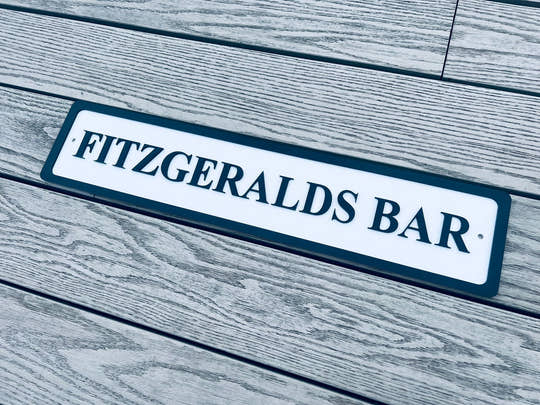 Personalised bar name sign mounted on outdoor wall, perfect for home bar, man cave, or garden pub decor