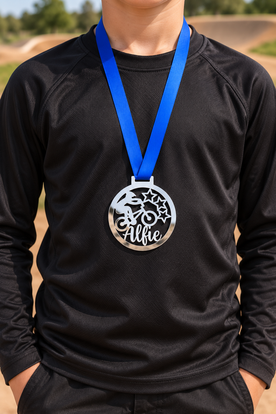 silver mirror acrylic personalised BMX medal on a blue ribbon worn around the neck