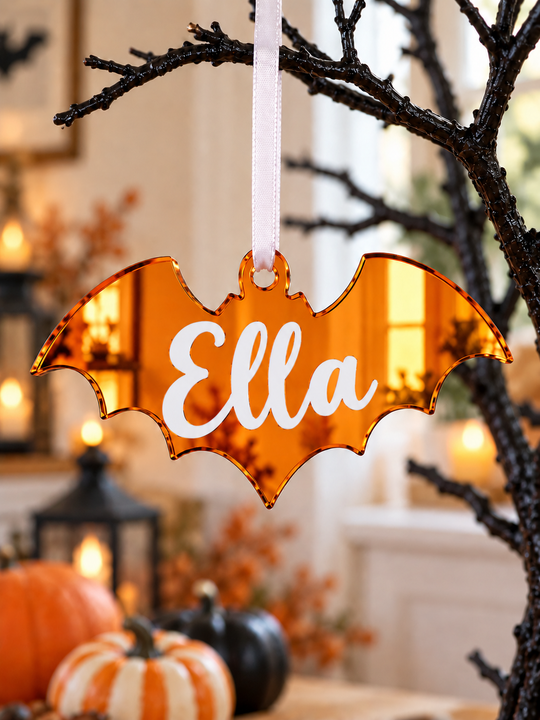 Personalised bat Halloween tree decoration in orange mirrored acrylic with the name in white