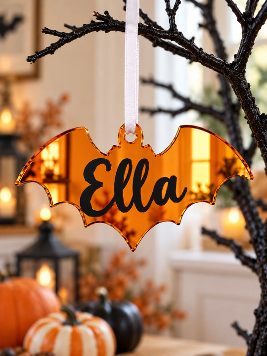 Personalised bat Halloween tree decoration in orange mirrored acrylic with the name in black