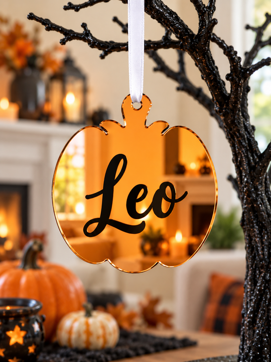 Personalised pumpkin Halloween tree decoration in orange mirrored acrylic with the name in black