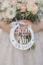 Load and play video in Gallery viewer, Bride holding pastel pink and cream wedding bouquet with personalised silver mirror horseshoe engraved Jenn &amp; Ian 12th April 2025
