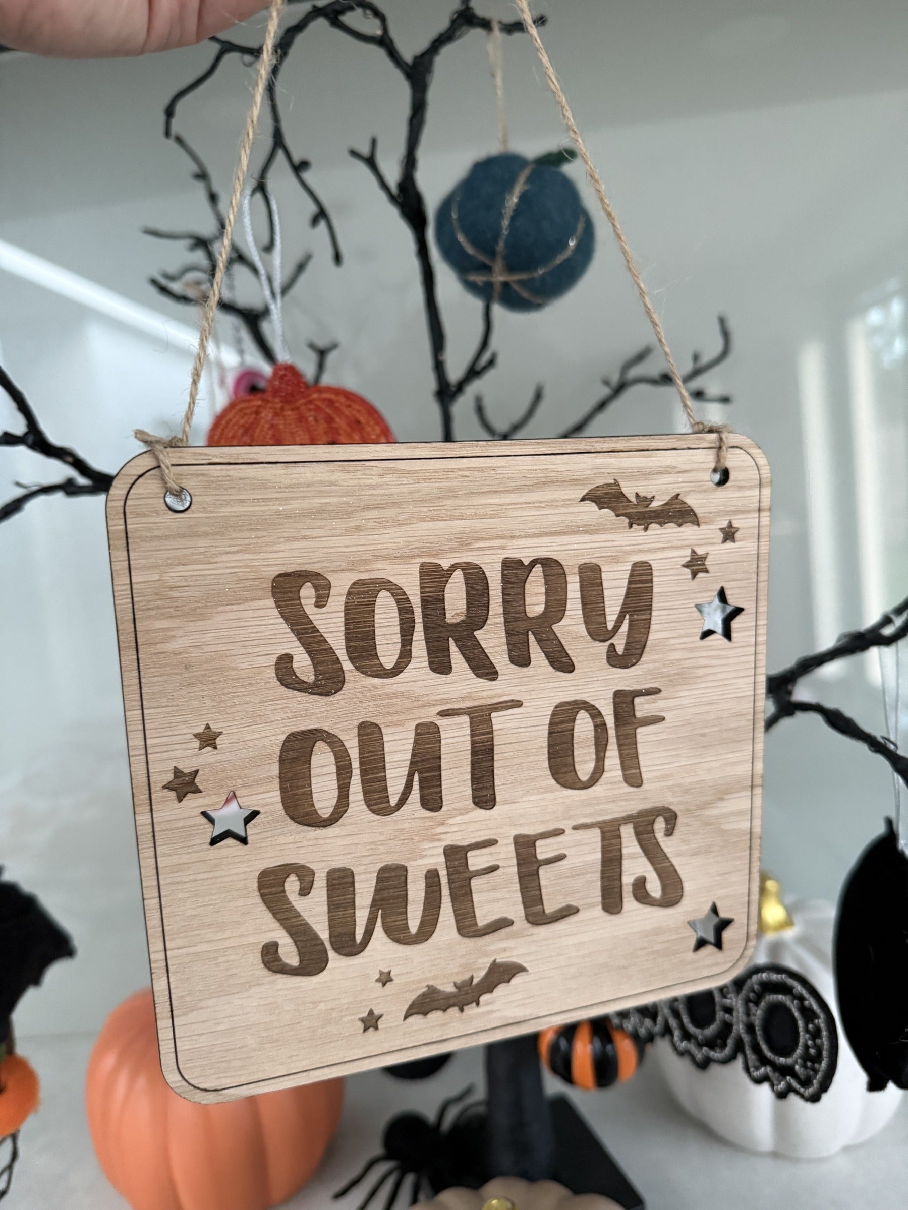 Load image into Gallery viewer, Oak Sorry out of sweets Halloween hanging sign with bats and stars on jute twine
