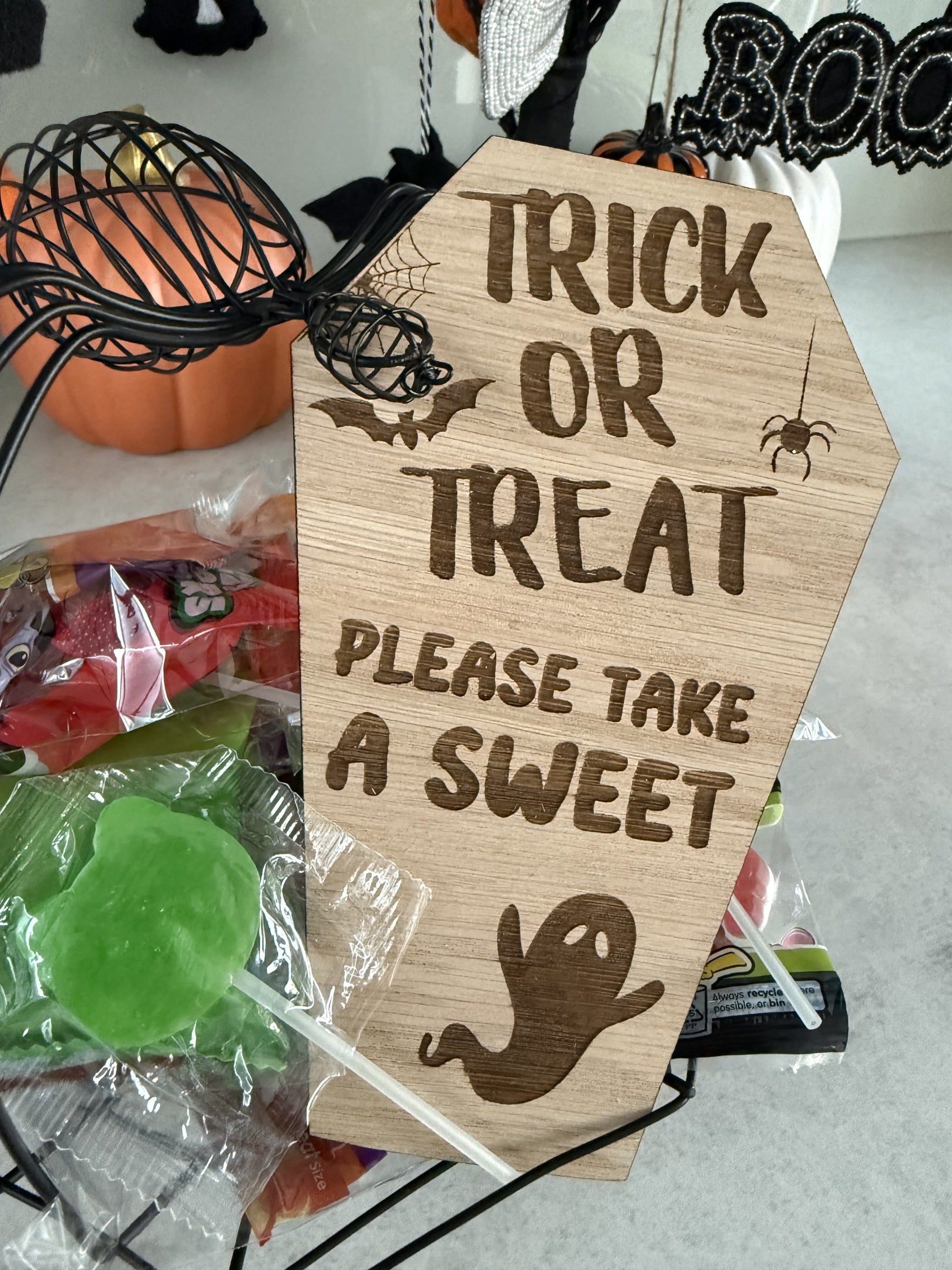 Load image into Gallery viewer, Coffin-shaped oak trick or treat sign with an engraved ghost, bat and spider
